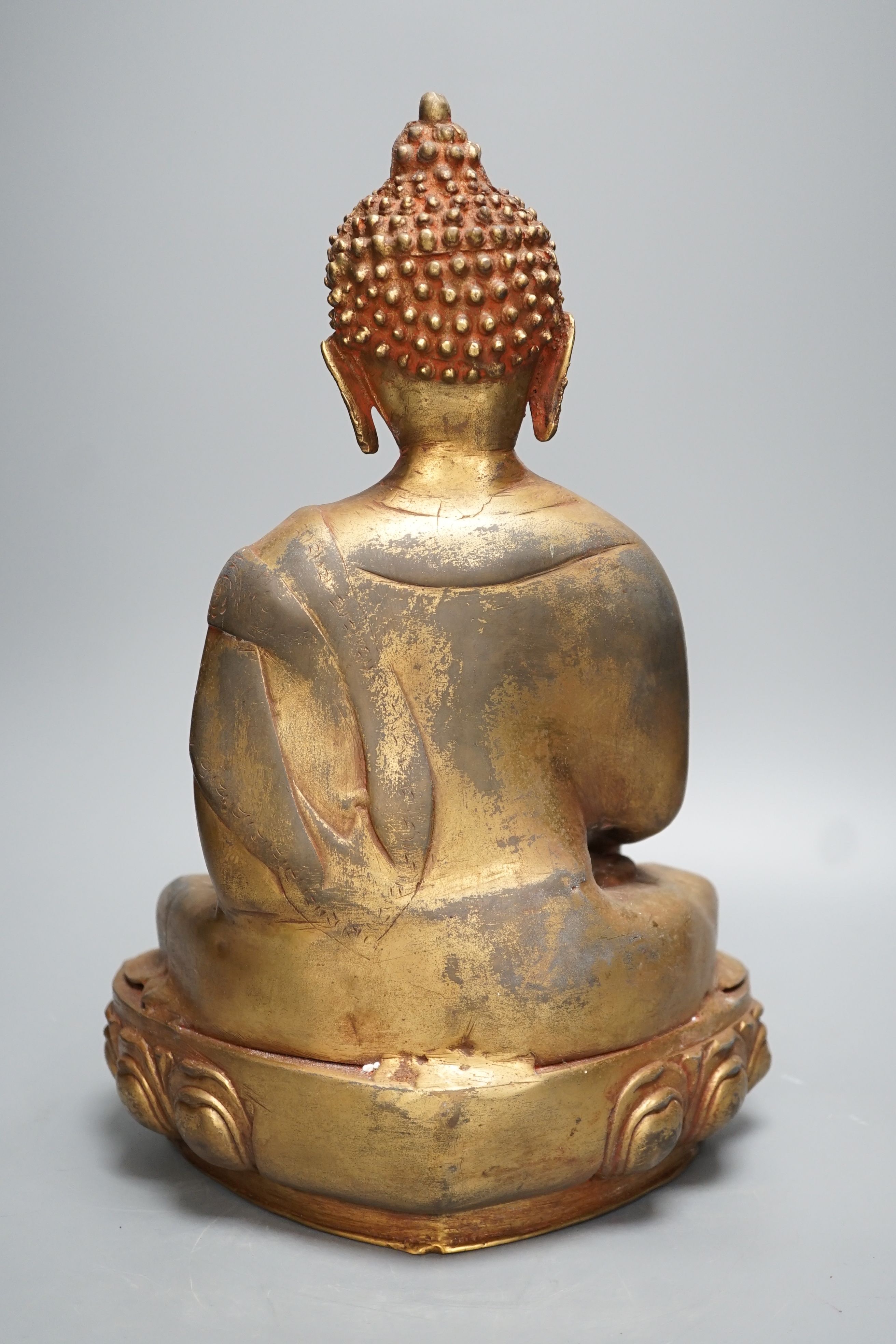 A gilt brass seated figure of Buddha - 38cm high